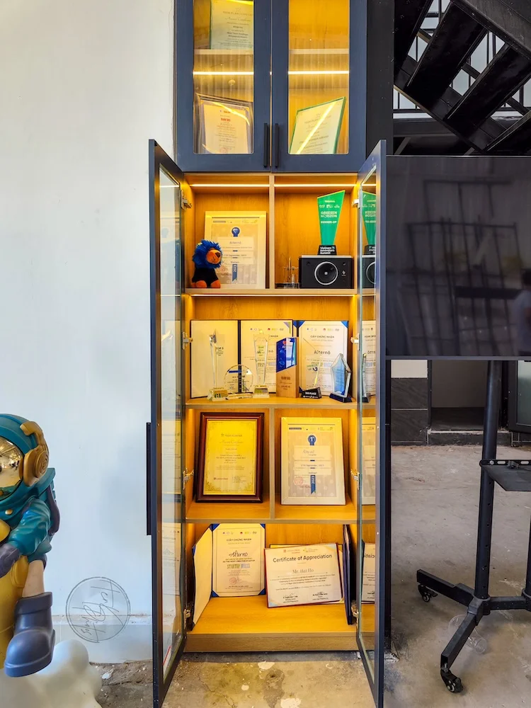 Glass cabinet packed with competition trophies and award certificates